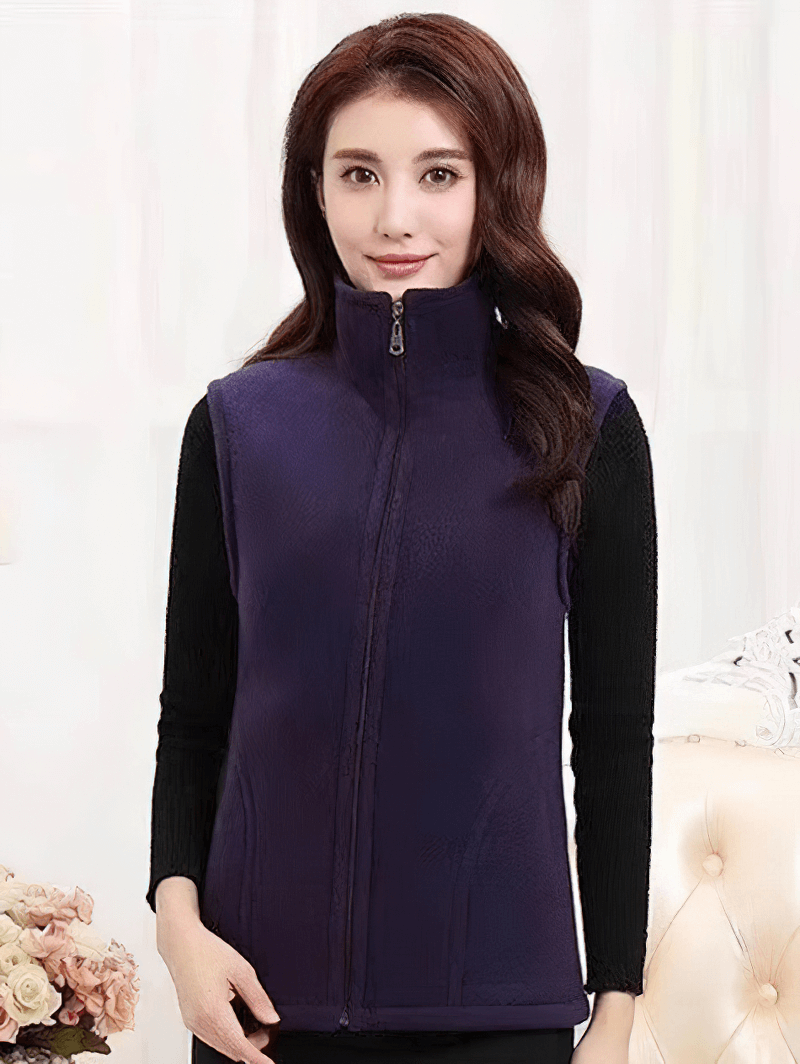 Cozy female fleece vest with zipper and pockets, perfect for warmth and style. Ideal for layering in chilly weather.